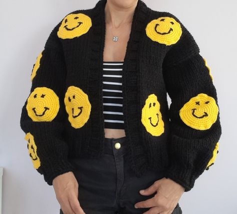 The cardigan is knitted with soft and thick yarns and is completely handmade. The cardigan is 50... 55 cm long and can be knitted to the desired length. The emoji motifs on it are fixed with 3D processing technique. The cardigan, which can be machine washed in a short program, does not fade. So why the affordable price? As HeyÇKnitting, I trust my designer cardigans and want all women in the world to wear these designs with pleasure COLOR: black. (Desired color can be knitted upon order.) MODEL: Black Chunky Knit Long Sleeve Cardigan, Black Chunky Knit Winter Cardigan, Black Chunky Knit Cardigan For Winter, Trendy Black Knit Sweater, Black Crochet Outerwear For Winter, Black Knitted Cardigan For Fall, Hand Knitted Black Sweater For Winter, Trendy Black Chunky Knit Outerwear, Fitted Black Knitted Sweater Coat