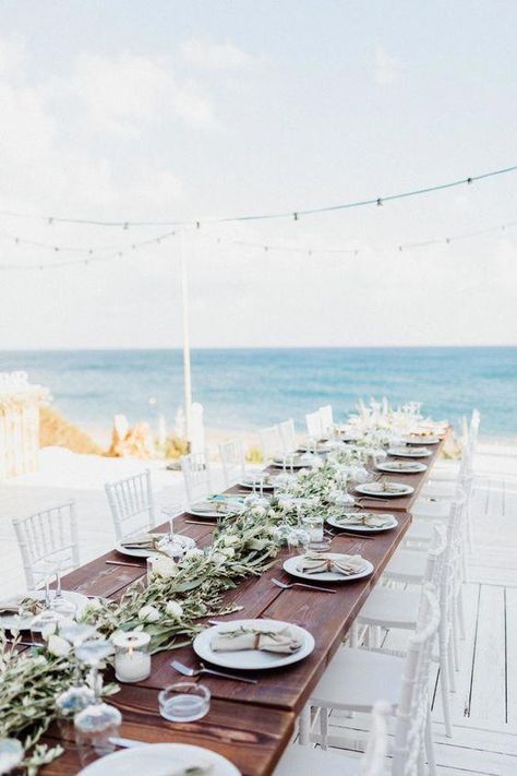 Beach wedding reception with garland table decor | Image by Jonas Mueller Photography #beachwedding Beach Wedding Aisles, Long Table Wedding, Beach Wedding Decorations Reception, Beach Wedding Centerpieces, Beach Wedding Reception, Rhodes Greece, Beach Wedding Photos, Beach Ceremony, Greenery Garland