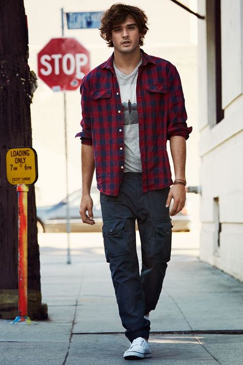 On relaxed days, Kaelin might go around in his same hiking pants and boots, but with a plaid shirt, open in the front. The T-shirt underneath would be his Alpha Squad shirt, to keep the orange theme going Red Check Shirt Outfit Men, Red Checked Shirt Outfit, Graphic Tee Outfit Men, Checked Shirt Outfit, Cargo Pants Outfit Men, Red Checked Shirt, Blue Cargo Pants, Marlon Teixeira, Shirt Outfit Men