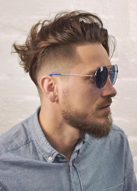 Undercut Swaving Hair - The undercut with sides being taper faded with the temple being blended into the beard makes the overall look. The line up with a pointy sharp angle shows off the details and the nitty-gritty of the look. The silky medium stranded top with highlight dye, wait until the wind gushes through that hair. Mens Fade Long On Top, Side Swept Hairstyles Men, Comb Over Fade Haircut, Swept Hairstyles, Medium Beard Styles, Guy Haircuts, Combover Hairstyles, Short Sides Long Top, Fade Undercut