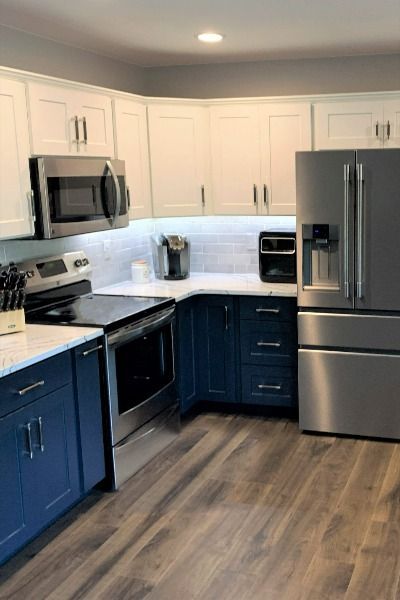 Straightening the peninsula made way for this flowing, open-concept Deep Blue Sea and White Ash kitchen. The fresh, airy look was enhanced with the Cambria Portrush quartz countertop and the efficiency was maximized perfectly with cabinet additions, modifications and four new organizers.
🍃Click to price YOUR kitchen transformation with our FREE online estimator and find our locations 
#kitchenremodeler #kitchenmakeover #kitchencabinetcolors #cabinetmakeovers #kitchendesign #cabinetrefinishing New Cabinet Doors, Two Tone Kitchen Cabinets, Types Of Countertops, Kitchen Finishes, Two Tone Kitchen, Kitchen Refresh, Kitchen Transformation, Refinishing Cabinets, Kitchen Remodel Design