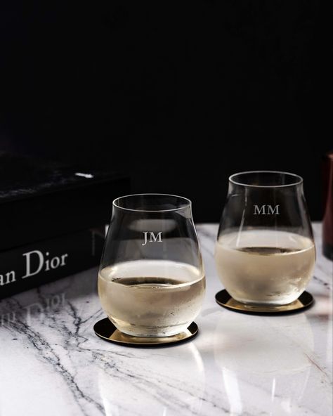 Two stemless wine glasses engraved with initials