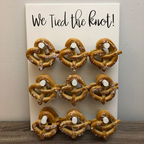 pretzel wall wedding display. If you love soft pretzels and want to create a one-of-a-kind pretzel display, pretzel bar, or wall at your wedding, here is what you need + where to buy pretzels in bulk for weddings. We also have tips on whether you should put the soft pretzels in... We Tied The Knot Pretzel, Pretzel Board, Pretzel Wall, Wedding Pretzels, We Tied The Knot, Pretzel Bars, Donut Decorations, Catering Display, Donut Wall