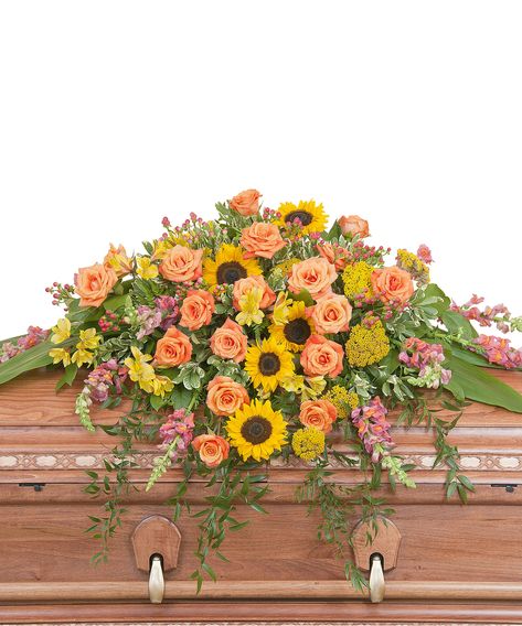 Our Heaven's Sunset Casket Spray features the colors of sunset in this beautiful spray of Sunflowers and Roses with accents of other premium flowers and foliage. As pictured approximately 44" wide and 36" deep.  SKUs: ,TMF-702,TMF-702,TMF-702 Casket Spray Wildflowers, Sunflower Casket Spray, Casket Floral Arrangements For Men, Casket Spray, Casket Flowers, Gravesite Decorations, Sunflowers And Roses, Sympathy Arrangements, Casket Sprays