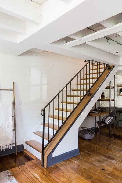 Staircase, Metal Railing, and Wood Tread Previously located in the kitchen, the staircase was moved to the space opposite the dining area, and was opened up with a delicate metal railing. Photo 71 of 793 in Best Staircase Photos from Before and After: A Dark 1880s Row Home Gets an Airy Makeover Move Staircase, Moving A Staircase, Staircase Metal Railing, Exposed Ceiling Joists, Staircase Metal, Intimate Lighting, Exposed Ceiling, House Remodeling Ideas, Row Home