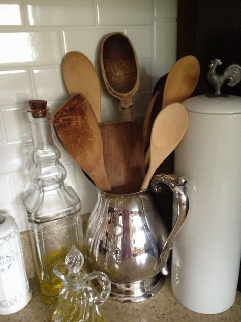 Asked myself what I was saving my old silver pieces for? Had been packed away for 43 years. Pitcher makes a perfect holder for my wooden utensil collection Wooden Utensils Decor, Decorating With Silver Pieces, Silver Tray Decor, Silver Plate Decor, Vintage Booth Display, Silver Display, Thrift Store Decor, Silver Tea Set, Kitchen Counter Decor