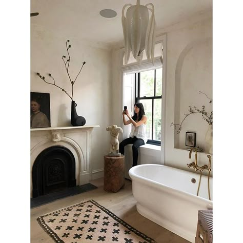 Documenting as i’m documented  Photo @nicole_franzen  .  Travertine walls + ceiling @kampstudios  Bathtub @watermonopoly  Rug vintage Moroccan Parisian Bathroom Decor, French Style Bathroom, Parisian Bathroom, Athena Calderone, Parisian Decor, White Tub, Bad Inspiration, Bathroom Red, Faux Fireplace