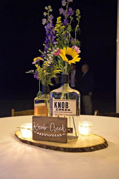 Bourbon Table Decor, Beer Bucket Centerpiece Ideas, Whisky Bottle Centerpiece Wedding, Bourbon Bottle Centerpiece Wedding Ideas, Bourbon Bottle Centerpiece, Whiskey Bottle Centerpiece, Wedding Tablescapes Round, Bourbon Wedding, Fall Wedding Tablescapes