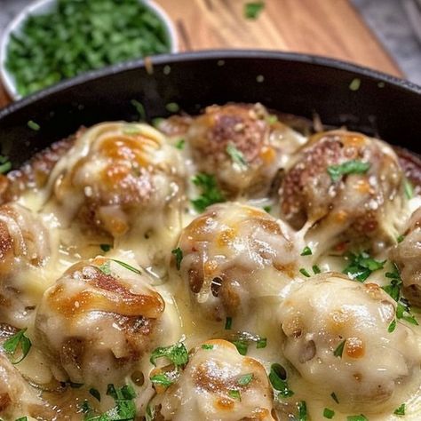 miarecipes on Instagram: "Dive into the heartwarming flavors of our French Onion Meatballs tonight! 🧅🧀 Perfectly caramelized onions and a cheesy topping make this dish irresistible. 😋  Ingredients:  1 bag (22 ounces) frozen meatballs, prepared according to package instructions 2 tablespoons unsalted butter 2 large yellow onions, thinly sliced into half-moon shapes 1 tablespoon all-purpose flour 1 ½ cups (12 ounces / 360 g) beef broth ¼ teaspoon kosher salt ¼ teaspoon black pepper 1 cup (113 g) mozzarella cheese, shredded 1 cup (113 g) Gruyere cheese, shredded Parsley, chopped for garnish Directions:  In a large oven-safe, non-stick skillet over medium-high heat, melt butter. Once melted, add the onions and sauté for 25-30 minutes, stirring occasionally, until they are very tender and ca French Onion Meatballs, Onion Meatballs, Cheese Stuffed Meatballs, Frozen Meatballs, Large Oven, Gruyere Cheese, French Onion, Moon Shapes, Meatball Recipes