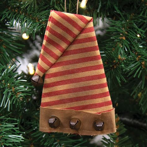 Our Striped Santa Hat Ornament is a rustic, tea stained fabric ornament accented with brown jingle bells. This ornament has a lot of antique charm and will make great addition to a primitive Christmas collection. Measures 5.5" by 3.25" and hangs by a string. Stained Fabric, Fabric Santa, Christmas Decorations Sewing, Christmas Primitive Crafts, Fabric Ornament, Hat Ornament, Hanging Display, Prim Christmas, Christmas Crafts To Make