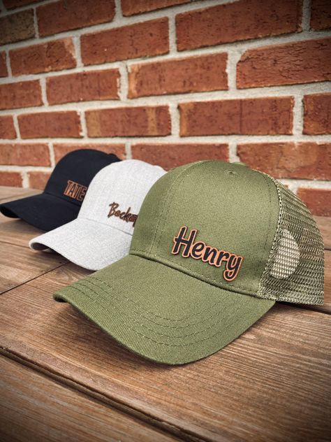 Who says toddlers can't be in style. This custom personalized leather name patch hat does just that. These hats are so cute on your little one!  Our toddler hats fit from 1-3 years old. Our Kids hats fit from 4-8 years old. These are SnapBack hats with a curved brim. We also offer SnapBack hats with a flat bill in our shop. We place the name on the right bottom side of the hat. If you would like the name elsewhere please let us know in the notes of your order, the personalization box, or the etsy messenger.  All signs, onesies, and products are hand-made by us in our shop located in Boston, KY. We print, cut, and engrave everything in house using our laser engraver and our DTG printer. **RETURNS We do not offer returns on any of our customized or personalized items as they are made specifi Diy Laser Engraver, Toddler Hats, Leather Patch Hat, Patch Hats, Engraving Ideas, Laser Design, Laser Projects, Personalized Hats, Patch Hat