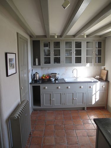 Grey cupboards and terracotta tiles.... try Farrow and Ball Manor House Grey for this Modern Country kitchen