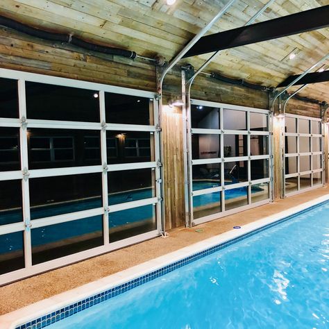 Indoor pool with glass garage doors Indoor Pool With Garage Doors, House Plans With Indoor Pool, Pool Enclosure Ideas, Farm Pool, Indoor Pool Ideas, Barn Pool, Small Indoor Pool, Indoor Pool House, Glass Garage