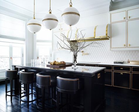 Three Ralph Lauren McCarren Large Globe Pendants hang over a black center island topped with a black marble countertop seating black leather barrel back counter stools placed on an ebony wood floor. Latest Kitchen Designs, Black Kitchen Island, Best Kitchen Designs, Kitchen Design Trends, Gold Kitchen, Transitional Kitchen, Luxury Kitchens, Kitchen Cabinetry, Black Kitchens