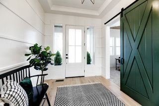 This entry by Solitude Homes is simply gorgeous!  I love the emerald green barn door that covers the office entry and the black and white rug and farmhouse bench.  #barndoor #barndoors #barndoorideas #entryideas #greendecorideas Green Entryway, Farmhouse Entry, Green Barn, Modern Farmhouse Design, Dry Creek, Interior Barn Doors, Farmhouse Living, Custom Home Builders, Farmhouse Design