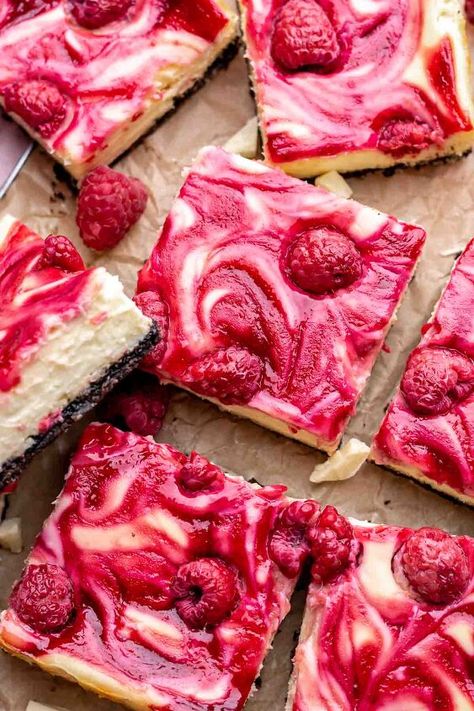 These easy raspberry cheesecake bars are mixed with melted white chocolate, baked onto a buttery chocolate cookie crust, and topped with a sweet and tart raspberry swirl with fresh raspberries.We know that chocolate and raspberry are a classic flavor combination, so we've used both white chocolate and normal chocolate in these cheesecake squares. It's simple and quick to make (no springform pan needed), and is perfect for a holiday party, gathering, or just because you're craving it!… No Bake Raspberry Cheesecake Bars, White Chocolate Raspberry Brownies, White Chocolate Raspberry Cheesecake Bars, Raspberry White Chocolate Bars, White Chocolate Rasberry Cheesecake, Raspberry Cheesecake Bars, Cheesecake Squares, White Chocolate Raspberry Cheesecake, Raspberry Sauce