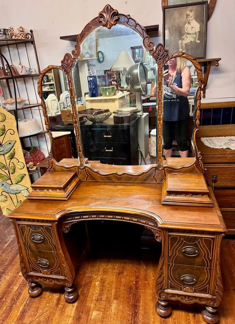 Beautiful 1920's antique Art Deco Neo Classical vanity with triple mirror and vanity chair.  Four deep drawers, dovetail construction with original brass hardware, the drawers have a slight bombay curve to them with wood molding all around.  Two jewelry boxes on top.  Bun feet, lots of carving, embellishments and beautiful detail.  46 x 18 x 27 and vanity chair measures 26 x 16 x 18 x 24".  Matching armoire and dresser available.   Very good original condition.   Free shipping to the West Coast, Vanity Art Deco, Old Hollywood Vanity Aesthetic, 1920s Dressing Room, Medieval Vanity, Thrifted Vanity, Wooden Vanity Bedroom, 2000s Furniture, Funky Vanity, Antique Makeup Vanity