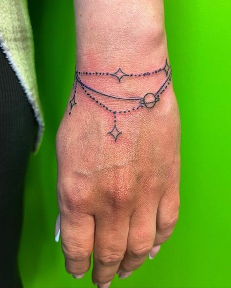 Bracelet Wrist Tattoo Tattoo Bracelet Wrist, Bracelet Tattoo Ideas, Bracelet Tattoos, Bracelet Tattoos With Names, Couple Wrist Tattoos, Anchor Tattoo Wrist, Bracelet Tattoo For Man, Cross Tattoo On Wrist, Wrist Band Tattoo