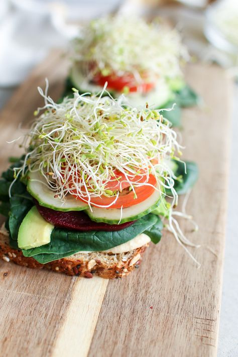 A colourful veggie sandwich stacked with fresh spinach, creamy avocado, crunchy cucumbers, tomatoes, beets and microgreens, smooshed between your favourite bread and smothered in caramelized onion hummus and creamy aioli. The ultimate sammy! Onion Hummus, Microgreens Recipe, Onion Sprouts, Cucumber Canning, Lazy Dinners, Micro Greens, Veggie Sandwich, Gourmet Vegan, Avocado Slices