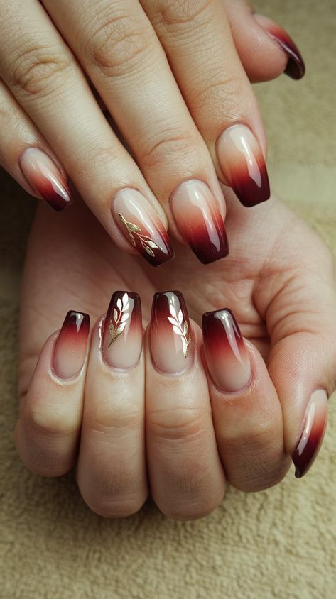 Transform your manicure game with this stunning burgundy ombre design on a chic beige base! The smooth gradient creates a rich, sophisticated look, while delicate gold floral accents add a touch of glamour and charm. Perfect for any occasion, these nails effortlessly blend elegance and creativity. Whether you’re heading to a special event or just want to elevate your everyday style, this nail art is sure to turn heads. #acrylicnails #septembernails #nailsdesign #fallnails Dark Ombre Nail Designs, Maroon Ombré Nails, Ombre Thanksgiving Nails, Maroon Ombre Nails Burgundy, Fall Wedding Nails For Bride Burgundy, Ombre Autumn Nails, Floral Fall Nails, Burgundy Nails With Gold Glitter, Maroon Ombre Nails