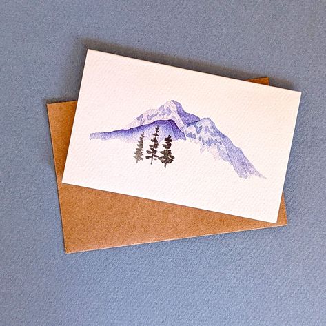 Gorgeous hand-painted watercolor mini-cards that are just oh-so-cute! Featuring a minimalist landscape with mountains and trees, the pack includes 6 mini cards and brown kraft-colored envelopes. These folded mini cards have a fun and beautiful minimalist design on the front, a blank interior, and a minimal backside. Their petite size makes them a favorite for kiddos and adults alike. Great for lunch box notes, gift card enclosures, or gift tags. Enough room for a small note, or just a simple to/ Winter Cards Handmade Simple, Mini Watercolor Paintings Simple, Watercolour Cards Simple, Watercolor Cards Ideas Simple, Simple Watercolor Cards, Mini Watercolor Paintings, Winter Cards Handmade, Mini Greeting Cards, Greeting Card Sentiments