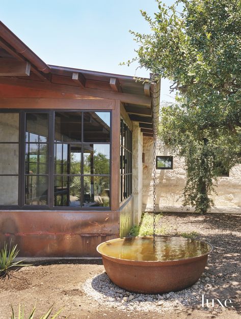 Steel kettles once used for boiling sugar were salvaged from the wife's childhood home in Louisiana and reinterpreted as water catchment containers for the rainwater system by Ten Eyck. Jack Harrison of Structural Design Consulting handled the home's structural engineering, while HVAC was done by Ray Butler of Southwest Mechanical Services. Hunter Douglas Roller Shades, Roof Top Patio, Lake Flato, Water Catchment, Rocky Mountain Hardware, Masonry Construction, Hill Country Homes, Texas Hills, Copper Roof