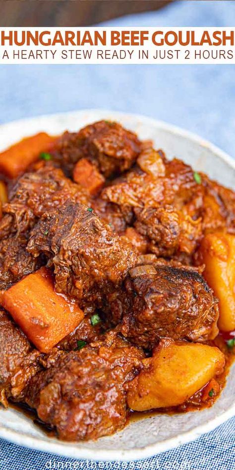 Hungarian Beef Goulash is a thick, hearty stew made from tomato paste, beef, veggies and a blend of spices on a bed of chopped potatoes and carrots. Ready in about 2 hours. #hungariangoulash #beefgoulash #hungarianbeefgoulash #stew #beefstew #dinner #dinnerthendessert Hungarian Beef Stew, Hungarian Beef Goulash, Hungarian Goulash, Hearty Stew, Beef Goulash, Potatoes And Carrots, Stew Meat Recipes, Goulash Recipes, Hungarian Recipes