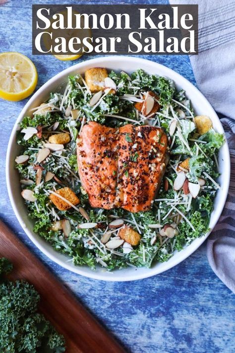 white bowl with caesar salad made with kale, topped with salmon, croutons, almonds, and parmesan cheese Baked Salmon Salad Recipes, Salmon And Kale Recipes, Salmon Ceasar Salad Recipe, Kale Caesar Salad Recipes, Salmon Kale Salad Recipes, Kale Salmon Salad, Kale Cesar Salad, Salmon Kale Salad, Salmon Kale Caesar Salad