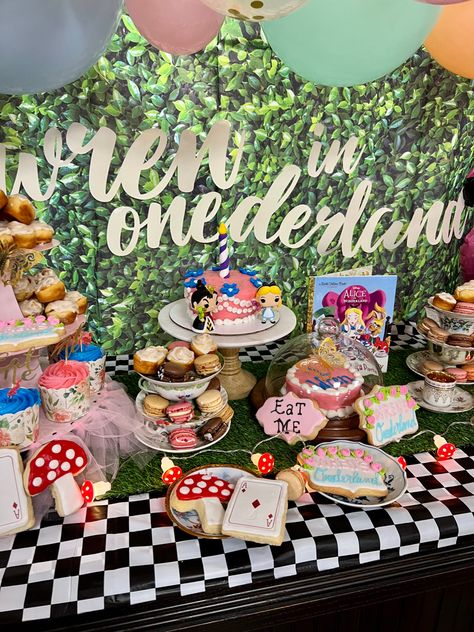 Alice in wonderland dessert table first birthday party decorating ideas One Derland First Birthday Girl, Alice In Onederland Table Decor, Onederland Birthday Party Girl, Alice In Wonderland First Birthday Smash Cake, Alice In Onederland First Birthday Centerpieces, Alice In Wonderland 1st Birthday Photos, Alice In Onederland First Birthday Candy Table, Birthday Party Dessert Table, Baby Olivia