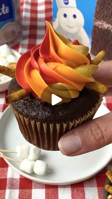 Pillsbury Baking on Instagram: "Cozy around the fire with these adorable Campfire Cupcakes🧁

You’ll Need:⁠
1 box Pillsbury Devils Food Cake Mix⁠
Additional ingredients to prepare cake mix per package instructions⁠
2 tub Pillsbury White Frosting⁠
Red, orange and yellow gel food colour⁠
Pretzel sticks⁠
Plastic Wrap⁠
Toothpicks⁠
Mini marshmallows⁠
⁠
Step 1: Prepare cupcakes according to package instructions. Let cool completely.⁠
Step 2: Divide the 2 tubs of white frosting into 3 bowls and color each with red, orange and yellow gel food color⁠
Step 3: Place a piece of plastic wrap down on a clean surface⁠
Step 4: Spread the red frosting in a thick line onto the plastic wrap, repeat with the orange and yellow frosting keeping the colors next to each other.⁠
Step 5: Using the plastic wrap, rol Fire Cupcakes, Campfire Cupcakes, Red Cupcakes, Devils Food Cake Mix Recipe, Pretzel Sticks, White Frosting, Devils Food, Cupcake Frosting, Gel Food Coloring