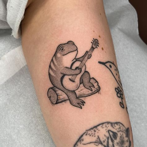 A cutie frog playing guitar 🎶✨ thank you Lotte ! Made at @truelovetattoocollective ✨ Bookings are open for May ! 💛🖤 Frog Playing Guitar Tattoo, Toad Tattoo, Frog Playing Guitar, Portfolio Reference, 12 Tattoos, Frog Tattoo, Branch Tattoo, Frog Tattoos, Guitar Tattoo