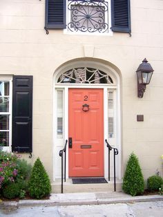 Popular colors to paint an entry door : Coral or salmon color - they say is best with neutral-colored home Coral Front Doors, Orange Front Door, Coral Door, Green Siding, Tan House, Shutter Colors, Orange Door, Kelly Moore, Black Shutters