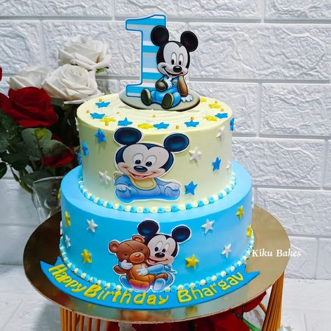 Baked with love 💕 Celebrate your little one's first birthday in style with our delightful two-tier Black Forest cake, adorned with a charming Mickey Mouse theme. The bottom tier features a vibrant blue hue, while the top tier is adorned with cheerful yellow color, perfectly capturing the spirit of Mickey's world. Adorned with fondant stars in blue, yellow, and white, the cake sparkles with magic. At the center of each tier, an edible photo of Mickey Mouse brings the beloved character to life... Fondant Stars, Tire Cake, Mickey 1st Birthdays, Mickey Mouse Birthday Cake, Baked With Love, Mickey Mouse Theme, Mickey Mouse Cake, Black Forest Cake, Forest Cake