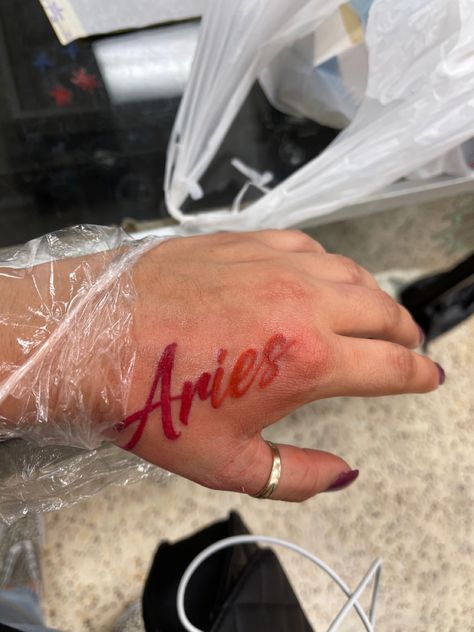 Red Ink Tattoo : Aries  
Hand placement Cursive Red Ink Tattoo, Aries Tattoo Black Women, W A Y S Tattoo Red, Aries Neck Tattoo, Aries Word Tattoo, Aries Hand Tattoo, Aries Aesthetic Tattoo, Red Name Tattoo, Red Ink Tattoos On Black People