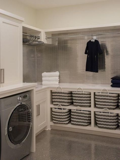 Contemporary laundry room features ivory shaker cabinets paired with white quartz countertops and mini stainless steel tili backsplash. Unfinished Basement Laundry, Contemporary Laundry Room, Laundry Room Storage Shelves, Room Storage Diy, Basement Laundry Room, Dream Laundry Room, Basement Laundry, Laundry Room Layouts, Smart Tiles