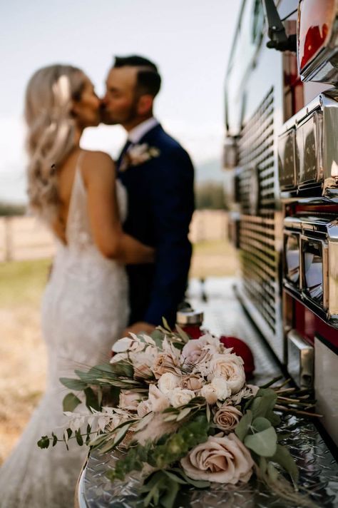 Bride and Groom in Front of Fire Truck with flowers in foreground. Pemberton Valley Wedding Firehouse Wedding Reception Ideas, Firefighter Wedding Theme, Firehouse Wedding Photos, Fire Truck Wedding Photos, Wedding Truck Photos, Truck Wedding Pictures, Firefighter Wedding Ideas, Fire Department Wedding, Firefighter Wedding Photos