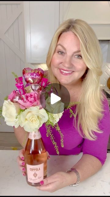 Amy Locurto - Disney Fan & Lifestyle Blog on Instagram: "DIY Wine Bottle Flower Bouquet is a beautiful floral arrangement craft to make with champagne or your favorite wine bottle! 💜—> Comment “WineFlowers” and I’ll send you the details and directions. This easy to make floral arrangement and candy bouquet would make a great centerpiece and perfect for Valentine’s Day, Mother’s Day, or a birthday present! #valentinesday #livinglocurto #flowerarrangement #valentinesdaygift  #mothersdaygift #flowercenterpiece #winebouquet #champagnebouquet #winegift #diygiftideas #diygifts #winelover #flowerbouquet #easyflowerarrangement #birthdaygiftsforher #candybouquet" Wine Mothers Day Gifts, Wine Bottle And Flowers Bouquet, Mother’s Day Vase Ideas, Flowers On A Wine Bottle, Wine Bottle Flower Bouquet Diy, Flower Bouquet With Wine Bottle, Wine Bottle Flower Arrangements Gift, Champagne Bottle Flowers Bouquet, Mother’s Day Centerpieces