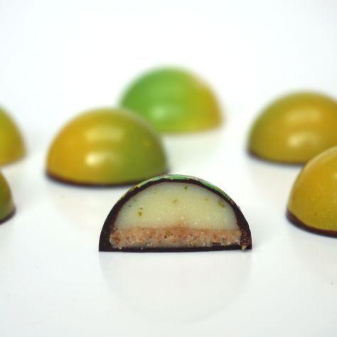 Handpainted bonbon with zesty lime cheesecake filling and crunchy ginger base Bonbon Filling Recipe, Bonbon Filling, Chocolate Bonbons Recipe, Bon Bons Recipe, Christmas Cookies Packaging, Contemporary Wedding Cakes, Chocolate Bonbons, Chocolate Recipes Homemade, Lime Cheesecake