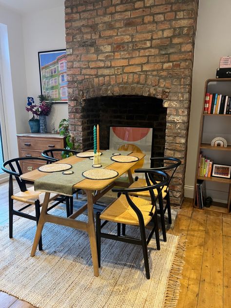 wooden dining table, dining room styling, brick fireplace, maximalist decor Dining Table By Fireplace, Fireplace Maximalist, Exposed Brick Dining Room, Brick Dining Room, Dining Room Styling, Exposed Brick Fireplaces, Dark Dining Room, Table Dining Room, Room Styling