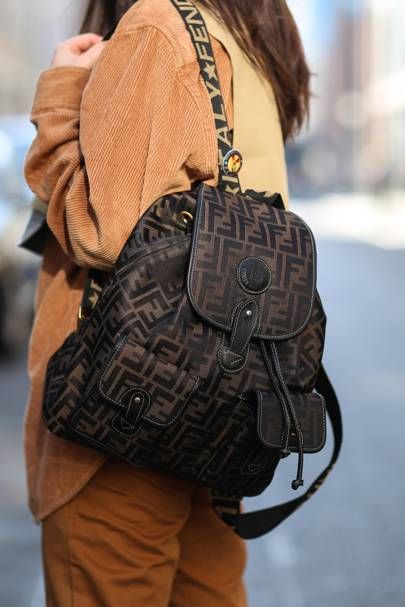 Street style: The Best New Ways To Wear A Backpack. | British Vogue Branded Backpacks, Fendi Backpack, Transitional Fashion, Backpack Outfit, Street Style Bags, Luxury Backpack, Attention Seeking, Fall Trends Outfits, School Things