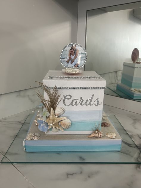 This Beach inspired Gift Card box will be the perfect addition to any wedding,anniversary or beach themed event. It will look absolutely stunning on your gift table. Personalized with Photo box is white but I can do different colors for tulle and ribbon based on preference  Box with base measures: 12Lx9Wx9H Shell measures an additional 3in in height. Elegant Beach Party Decorations, Beachy Wedding Centerpieces, Beach Quinceanera Ideas, Beach Theme Quinceanera, Diy Beach Wedding Ideas, Tiffany Blue Beach Wedding, Kourtney Wedding, Beach Wedding Reception Ideas, Mermaid Theme Wedding