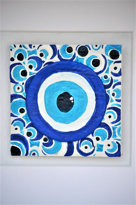 Clay painted evil eye on bas-relief wooden tile for bad spirits and evil gossips keeping away! Find more unconvetional decorate ideas on greekshadesofblue on instagram... #evileye#ceramicevileye#claygoodluckcharm#blueevileye#bluedecor#claydecor#ceramictile#mixedmediaart#turquoisedecor#bluewhitedecor#greekart Tile Painting Ideas Art, Evil Eye Painting Ideas, Evil Eye Painting Canvases, Evil Eye Art Painting, Evil Eye Canvas Painting, Painting Evil Eye, Evil Eye Painting, Beginner Painting On Canvas, Decorate Ideas