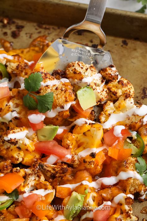 Cauliflower Nachos on a baking sheet with some being scooped up with a spatula Cauliflower Nachos, Watermelon Sorbet Recipes, Beet Pasta, Carrot Raisin Salad, Football Treats, Nacho Toppings, Sorbet Recipes, Recipes Appetizers And Snacks, Roasted Cauliflower