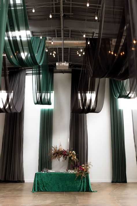 Create a striking and sophisticated ambiance with our dramatic black and green ceiling draping. Perfect for modern weddings seeking a bold statement. Transform your wedding venue! Contact We've Got It Covered for a free consultation. Black Wedding Draping, Black Wedding Drapery, Green Wedding Fabric With Traditional Drape, Green Wedding Fabric In Traditional Drape, Black Embroidered Wedding Fabric With Traditional Drape, Ceiling Draping Wedding, Fairy Lights Ceiling, Wedding Decor Black, Green Wedding Decor