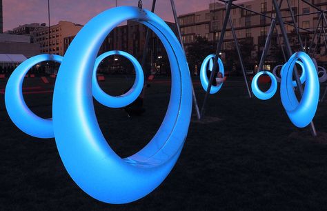 SWING TIME is an interactive playscape composed of 20 illuminated ring-shaped swings. The installation activates a temporary park between the Boston Conventi... Installation Interactive, Interaktives Design, Public Seating, Astuces Diy, Playground Design, Interactive Installation, Urban Park, Urban Furniture, Street Furniture