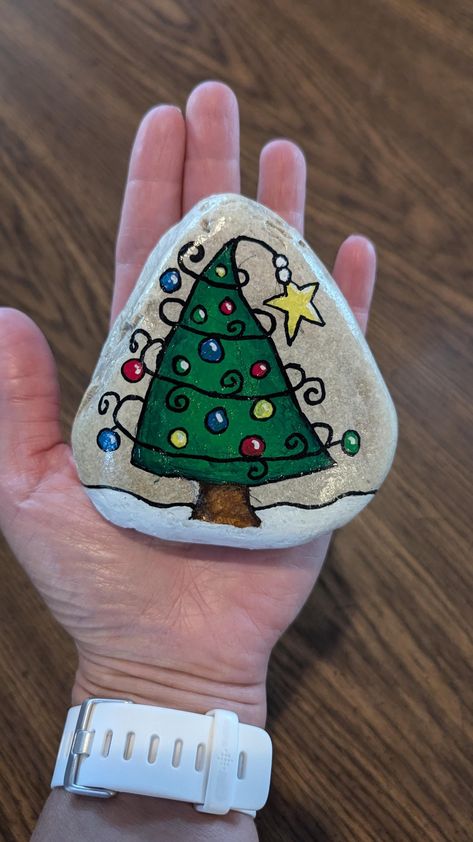 Handmade painted Christmas tree rock. Rock Painting Santa, Easy Christmas Rock Painting, Christmas Stones Rock Art, Rock Art Christmas, Penguin Painted Rocks, Christmas Tree Painted Rocks, Christmas Tree Rock Painting, Christmas Rocks Painted Ideas, Christmas Painted Rocks Ideas