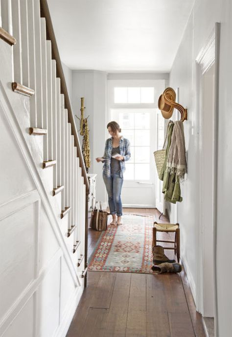 This is What Happens When a Small-Town Farmhouse from the 1800s Gets Restored:  Sarah stands in the entryway, accessorized with a rug and various coat hangers. Farmhouse Staircase, Staircase Styles, Staircase Wall Decor, Stairway Decorating, House Staircase, Staircase Makeover, Staircase Wall, Stair Landing, Painted Stairs