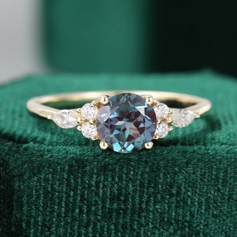 Item description ✦ Handmade, high-quality item! ✦ Material: 925 Sterling Silver Solid 10k/14K/18K GOLD (can be made in white/rose/yellow gold) Engagement ring ✦ Center stone: Lab Alexandrite. ✦ Size/Weight: Round  Cut 7mm. ✦ Side stones: Round 1.8mm marquise 2x4mm diamonds or moissanite. Any ring size can be made, if the ring size is not in the option list ,contact me. As it is handmade, It needs 1-2 weeks to finish and then be shipped by USPS or DHL. Return policy: We offer 14 days return policy. For any reason, if you are not completely satisfied with your order, you may return it for a refund. Buyer is responsible for the handcraft fee (15%-30% of the total price) and the return shipping cost. Gold Alexandrite Engagement Ring, Ring Inspo, Birthday Gift Ring, June Birthstone Ring, Moissanite Wedding Ring, Alexandrite Engagement Ring, Alexandrite Ring, Cluster Engagement Ring, Sterling Silver Engagement Rings