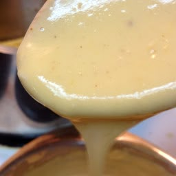 Quick and easy cheese sauce using american cheese. This versatile sauce can be adjusted to suit many dishes. - American Cheese Sauce Cheese Sauce Recipe For Fries, Cheese Fries Sauce, American Cheese Recipes, American Cheese Sauce, Fries Sauce, Brick Recipe, Easy Cheese Sauce, Cheese Sauces, Homemade Cheese Sauce