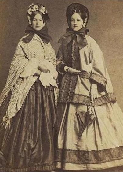 “Pair of women in outdoor wear ca. 1860s. Repository unknown.” Little Women Costumes, 1860s Dresses, 1860s Fashion, 19th Century Clothing, Era Fashion, 19th Century Fashion, Victorian Clothing, Outer Wear, Victorian Women